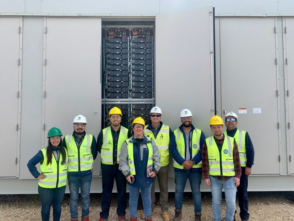 Group of Chilean engineers pose for a photo in-front of a battery storage 麻豆色情片鈥檚 Moss Landing Energy Storage Facility